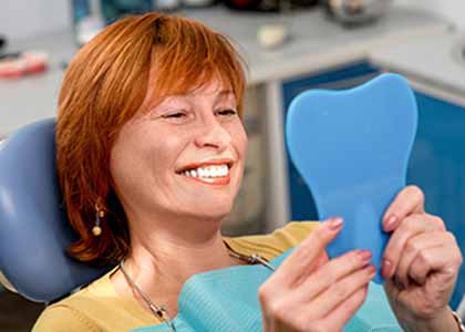 Dentist provides crowns and bridges for restoring broken or lost teeth